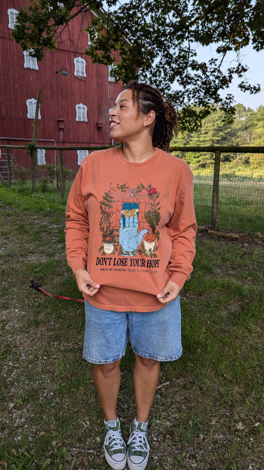 Woman wearing AFT x COSAP Co-op tee